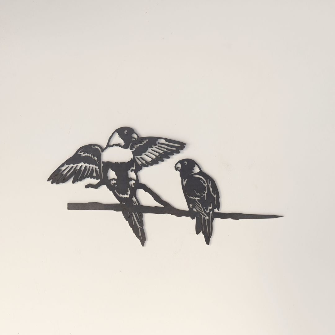 The Pair of Lorikeets by Metalbird Australia features two corten steel birds perched on a branch, one with open wings and the other with closed wings—an eye-catching piece of yard art for any outdoor space.