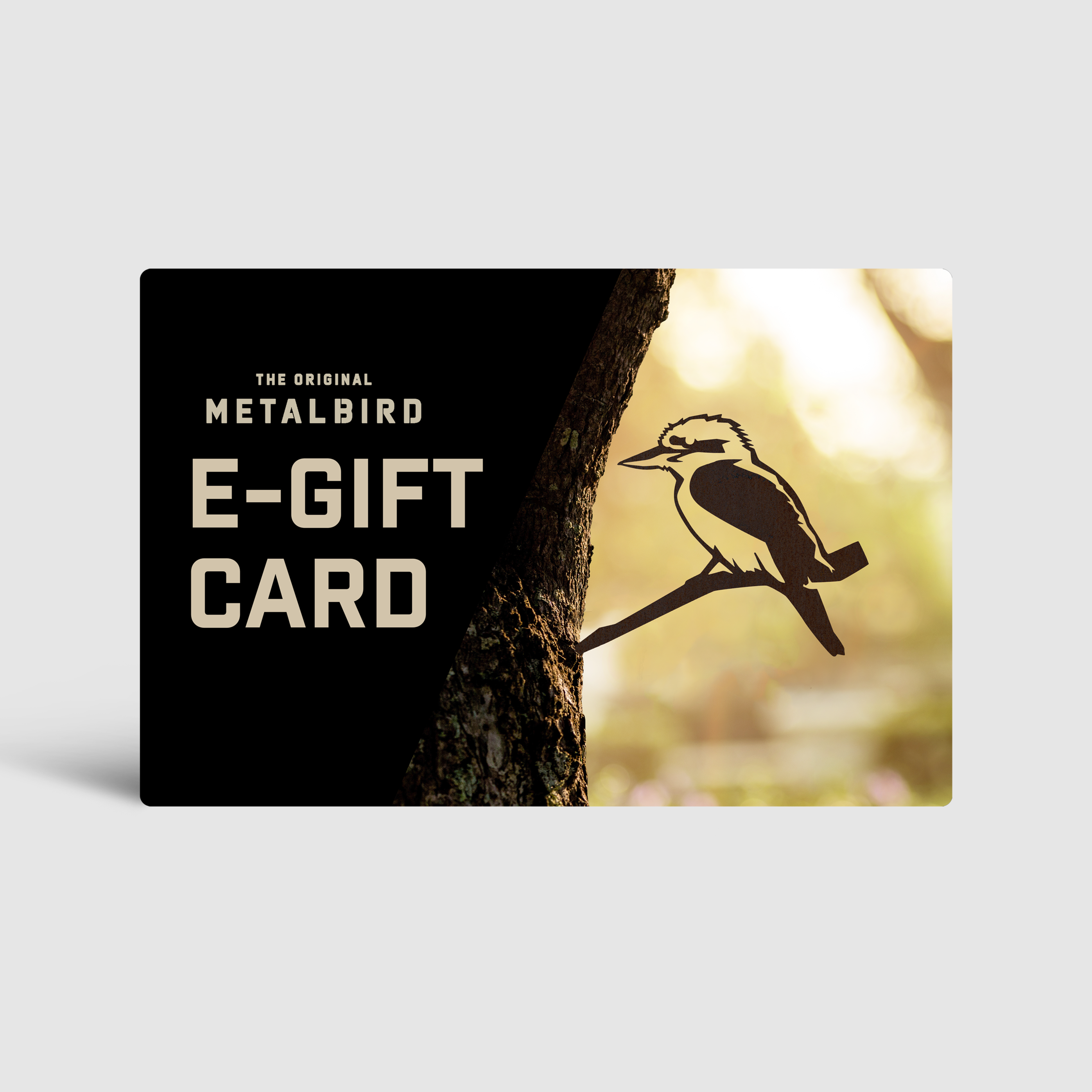 The Metalbird Australia E-Gift Card features a bird silhouette on a tree branch against a black background, echoing its yard art inspiration with blurred outdoor scenery and warm light.