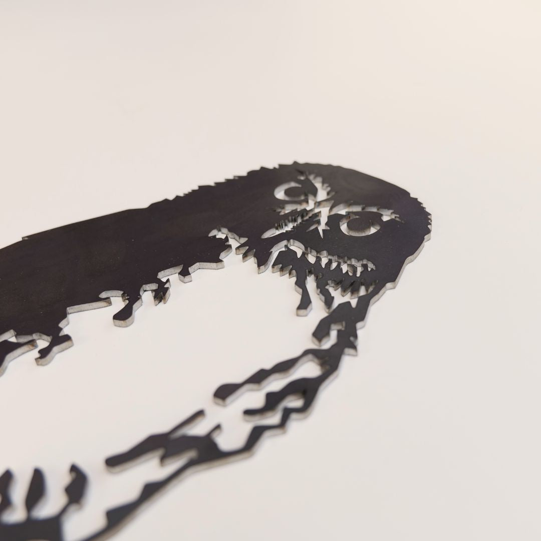 Close view of feather cut-outs in the Southern Boobook Owl steel silhouette.
