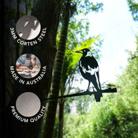 The Magpie by Metalbird Australia features a striking metal silhouette of an Australian Magpie perched on a branch, designed to attach easily to a tree—making it the perfect gift for nature lovers. Three circular badges highlight its 3mm Corten Steel construction, Australian craftsmanship, and premium quality. Lush greenery provides the ideal backdrop for this distinctive piece of Corten steel garden art.