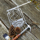 A premium THE PRANCING PONY™ metal sign by Metalbird Australia, featuring a prancing horse on weathered wood beside tools and pinecones—a perfect gift for fans.